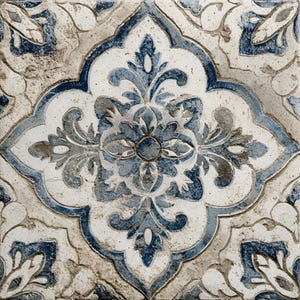 May include: Close-up of a decorative tile with a repeating floral pattern. The design features a central four-petal flower surrounded by stylized leaves and vines. The color palette includes shades of blue, white, and beige, creating a vintage aesthetic.