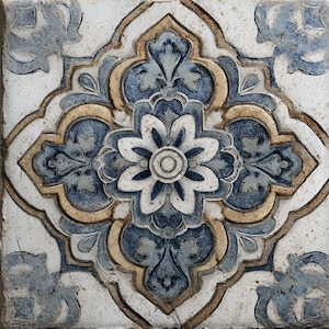 May include: Square ceramic tile with a raised floral design. The tile features a central flower with white petals and a blue center, surrounded by blue and tan decorative elements on a white background.