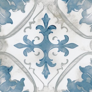 May include: A white tile with a blue and gray floral pattern. The pattern features a large, stylized cross in the center with smaller floral motifs around it.