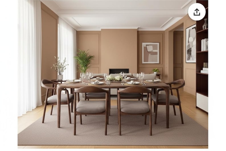 May include: A rectangular wooden dining table with six matching chairs featuring curved backrests and light grey upholstered seats. The table is set with white plates, glassware, and a central floral arrangement, positioned on a large rectangular rug.