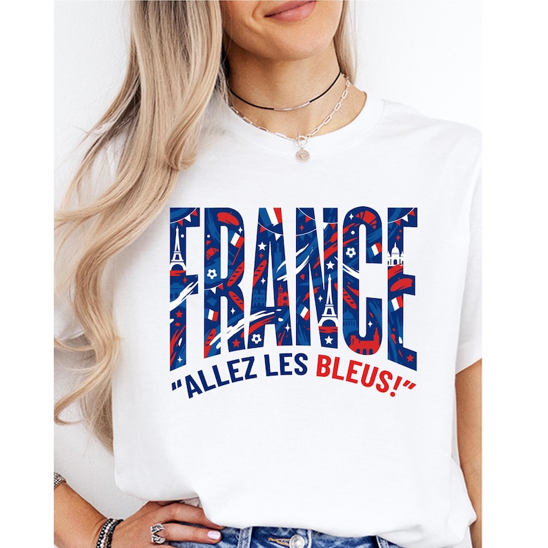 May include: White t-shirt with the word "FRANCE" in large blue letters filled with red and white patterns. Below the word "FRANCE" is the phrase "ALLEZ LES BLEUS!" in blue text.