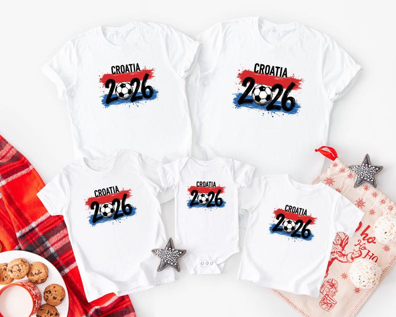May include: White t-shirts with a Croatia soccer design. The design includes the word "Croatia", the number "2026", and a soccer ball, with red, white, and blue accents. The shirts are available in various sizes.