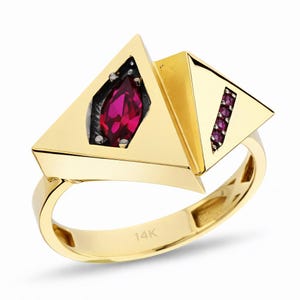 May include: A white ceramic mug with a black handle and the text "But First, Coffee" in a black, handwritten-style font. The mug is on a white surface.