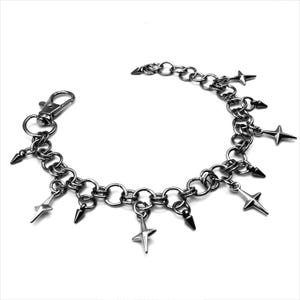 May include: A silver-toned chain bracelet with star and spike charms. The bracelet features a lobster clasp closure and is composed of interconnected circular links. The charms are evenly spaced along the chain, creating a bold, edgy aesthetic.