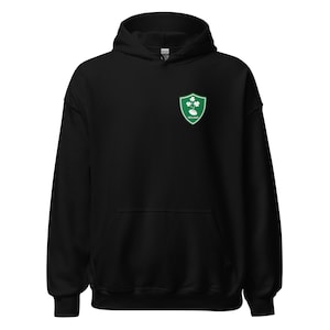 May include: Black hooded sweatshirt with a green Irish rugby team logo on the front. The logo features a shield with three shamrocks and a rugby ball.