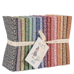 May include: A stack of floral fabric bundles in various colors, including black, green, blue, purple, and red. The bundles are tied with a ribbon that reads "Tilda QUILT COLLECTION". A tag with a drawing of a girl is attached.