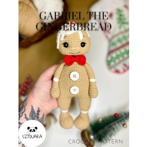 May include: A crocheted gingerbread man with a red bow tie, white icing details, and button accents. The text "GABRIEL THE GINGERBREAD" is displayed above the figure. The bottom of the image reads "CROCHET PATTERN".
