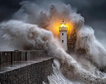 May include: A white lighthouse with a bright yellow light at the top stands against a stormy sea. Enormous waves crash over the stone pier, creating a dramatic scene under a dark, cloudy sky.