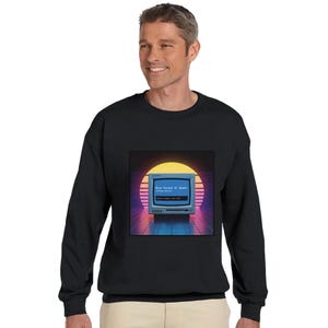 May include: Black sweatshirt with a retro computer graphic displaying "Blue Screen of Death". The design features a vintage monitor set against a sunset backdrop with blue and purple tones. The sweatshirt is a crew neck style.
