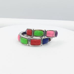 May include: A pair of silver hoop earrings featuring rectangular inlaid stones in vibrant shades of red, lime green, pink, blue, and purple. The earrings have a segmented design with each stone separated by a thin silver metal border.