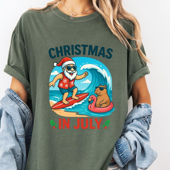 Surfing Santa Capybara Christmas in July T-Shirt, Gift Comfort Color Tee for Xmas Lovers Unisex Holiday Shirt, Beach Santa Tee with Capybara
