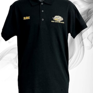 May include: A black polo shirt featuring a collar with three buttons. The right chest displays the name BURNS in gold embroidery. The left chest features an embroidered tank graphic with the text M88 and YOU CALL WE HAUL.