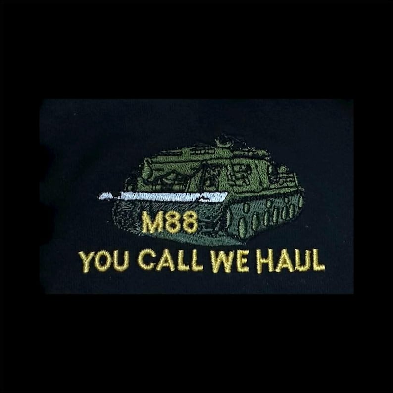 May include: An embroidered patch on a black fabric background featuring a green M88 tank. The text M88 is stitched in yellow thread above the text YOU CALL WE HAUL, which is also embroidered in yellow thread below the tank illustration.