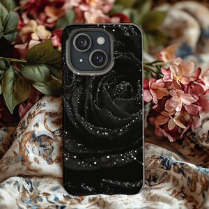 a phone case with a black rose on it