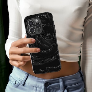 a woman holding a phone case with a picture of a rose on it