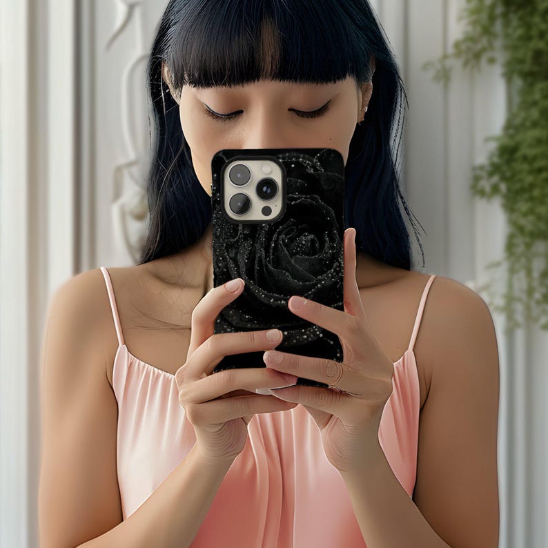 a woman in a pink dress holding a cell phone