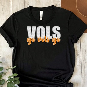 May include: Black t-shirt with a white and orange graphic that says "VOLS go vols go".