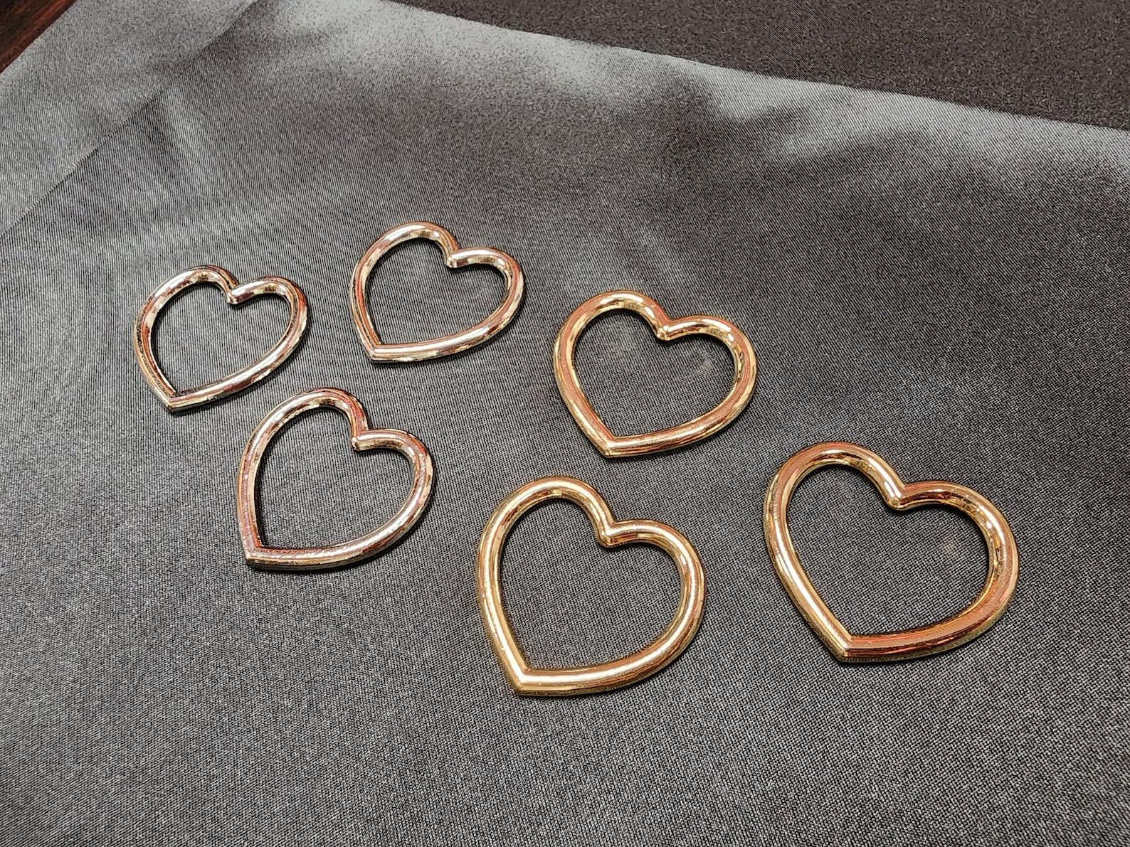 Gold heart-shaped metal O-rings for bondage ties and handmade BDSM restraints.