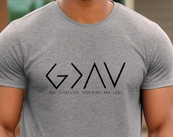 May include: A heather grey t-shirt with a black graphic of the words "G>A>V" and the text "GOD IS GREATER THAN HIGHS AND LOWS".