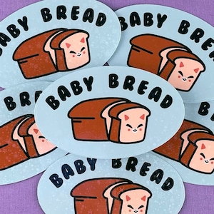 May include: Six blue and white oval stickers with the text "Baby Bread" and a cartoon illustration of a loaf of bread with a cat face.