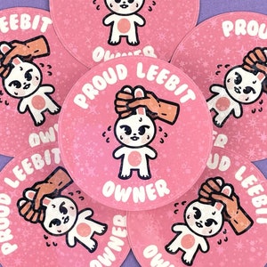 May include: Six pink round stickers with a white cartoon bunny and the text "Proud LeeBit Owner" on each sticker.