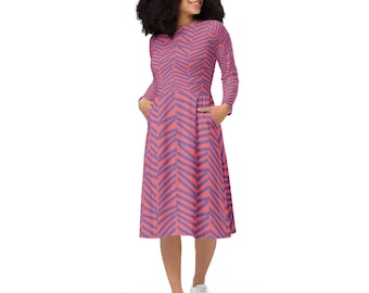 May include: A coral pink midi dress with a purple chevron pattern. The dress has long sleeves and pockets.