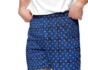 Può includere: Pantaloncini sportivi blu con motivo, sfondo bianco e un piccolo motivo floreale ripetitivo.
