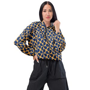 May include: A yellow and blue patterned hooded jacket with a zipper closure. The jacket has a drawstring at the waist.