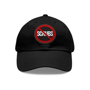 May include: A black baseball cap with a red circle and a diagonal line through it. The text "SCRUBS" is written in white letters inside the circle.