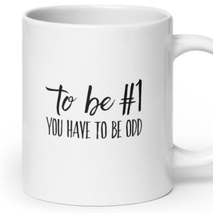 May include: White ceramic coffee mug with black text that reads "To be #1 you have to be odd".