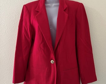 May include: A red blazer with a single gold button closure. The blazer has a classic, tailored fit and long sleeves.