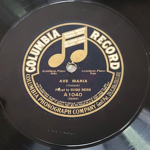 May include: A black and gold Columbia Record label with the text "Columbia Record" and "Ave Maria (Gounod)"  played by Guido Deiro. The record number is A 1040.