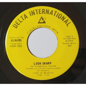 May include: A vintage vinyl record with a yellow label featuring the text "DELTA INTERNATIONAL" and "LOOK SHARP." The label includes the artist "The ALMARS," and the song's time is 2:09. The record is a 45 RPM.