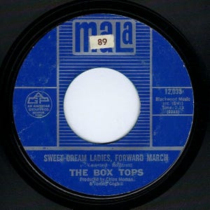 May include: A blue and silver 45 RPM record label with the text "mala 89" at the top. The record is titled "Sweet Cream Ladies, Forward March" by "The Box Tops". The label also includes the song's writing credits, production information, and publishing information.