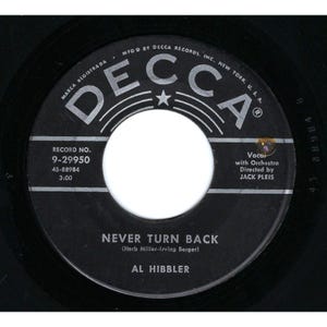 May include: A black vinyl record with the text "NEVER TURN BACK" by Al Hibbler. The record label features the Decca Records logo and other text including the record number, and the names of the song's writers and the orchestra director.