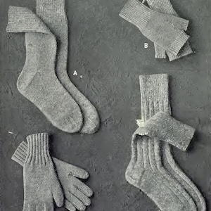 Puede incluir: Cuatro pares de calcetines y guantes sin dedos de punto gris. Los calcetines están doblados y los guantes están colocados planos. Los artículos están etiquetados con A, B, C y D.