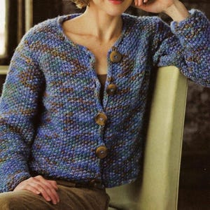 May include: A blue and brown knitted cardigan with a v-neck and five brown buttons.