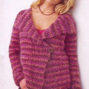 May include: A pink and purple striped cardigan with a large collar and a decorative pin. The cardigan is made of a soft, fuzzy yarn.