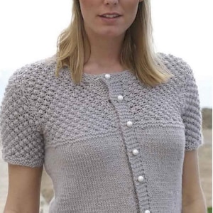 May include: A light gray short-sleeved cardigan with a button-up front and a textured stitch pattern. The cardigan has a round neckline and is made of a soft, lightweight yarn.
