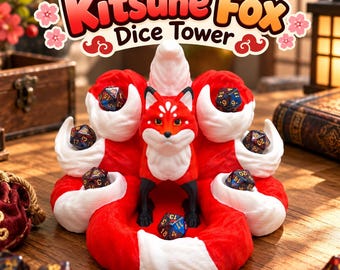 May include: A Kitsune Fox dice tower featuring a central red and white fox figure surrounded by multiple white-tipped red tails. The structure includes several small circular indentations designed to hold polyhedral dice, with dark dice placed within.