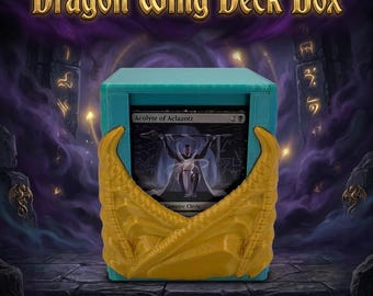 May include: A teal deck box featuring gold-colored dragon wing accents on the front. The box holds a trading card titled Acolyte of Aclazotz. The text Dragon Wing Deck Box is displayed in gold lettering above the container.