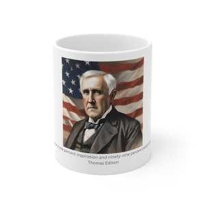 May include: White ceramic mug with a portrait of Thomas Edison in front of an American flag. The quote "Genius is one percent inspiration and ninety-nine percent perspiration" is printed below the image.  Thomas Edison is printed below the quote.