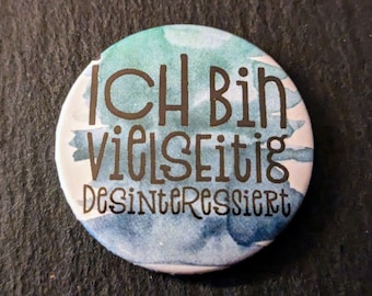 The saying "I am universally disinterested" is available as a button, fridge magnet, suction cup button, pocket mirror, bottle opener or with a crocodile clip.