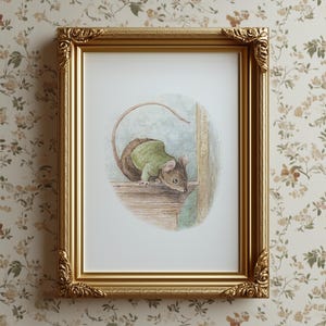May include: A framed art print featuring a watercolor illustration of a mouse wearing a green sweater. The mouse is perched on a wooden ledge. The frame is gold with ornate detailing, set against a floral wallpaper background.