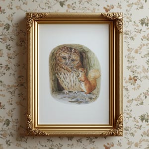 May include: A framed print featuring a watercolor illustration of an owl and a squirrel. The owl is brown and white, and the squirrel is reddish-brown. The frame is gold-colored with ornate detailing.