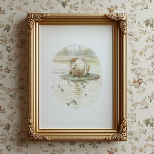 May include: A framed print featuring a whimsical illustration of a frog fishing on a lily pad. The artwork is set within a gold ornate frame. The print depicts a serene pond scene with fish and trees in the background. The frame is rectangular with decorative corners.