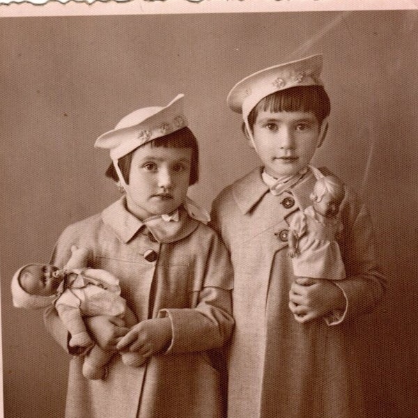 A wonderful example of children's fashion vintage photograph, Mugla / Turkey, 1940. Sepia photo of children holding dolls