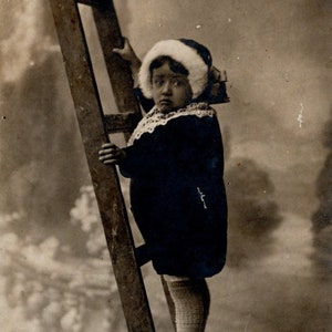 A Little Girl with an Interesting Dress and a Timid Look Climbing up the Wooden Stairs. Photo Simon, Grand Rue Pera, Constantinople