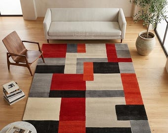 Alfombra geométrica roja y negra de lana tejida a mano, moderna y abstracta para el hogar.