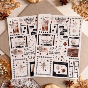 May include: Two sticker sheets with a vintage aesthetic. Each sheet features film strip frames, stars, and text elements in brown, black, and cream colors. The sheets are decorated with the text "BujoJej" and "Where thoughts become poetry."